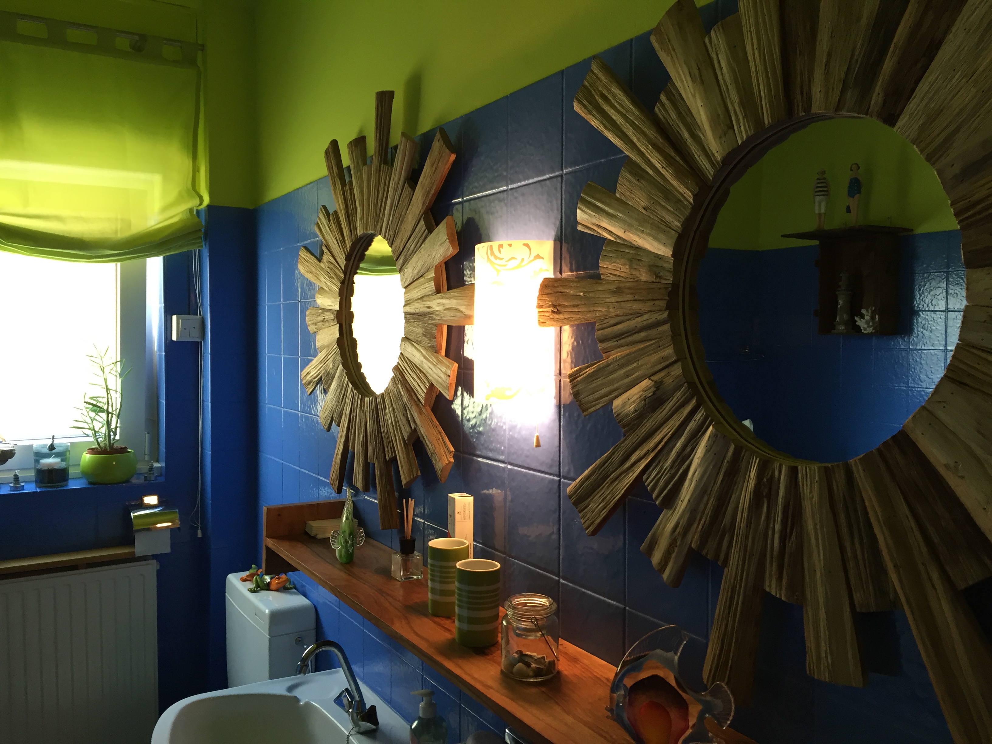 Bathroom with blue tiles and sunburst mirrors